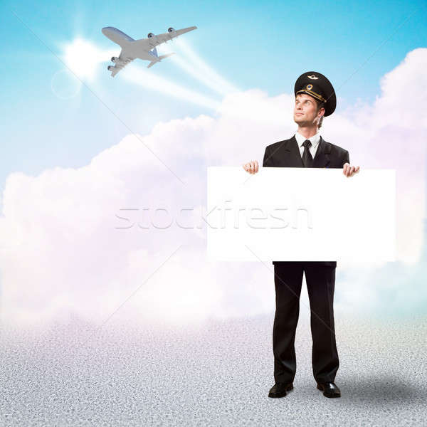 Stock photo: pilot in the form of holding an empty billboard