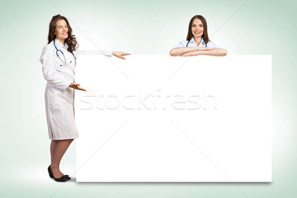 Two young woman doctor holding a blank banner Stock photo © adam121