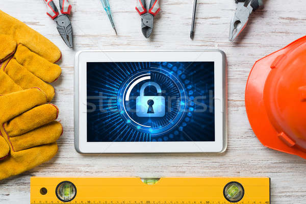 Web security and technology concept with tablet pc on wooden table Stock photo © adam121