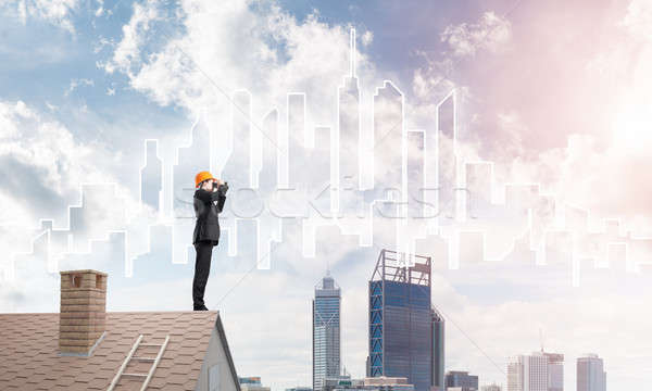 Engineer man standing on roof and looking in binoculars. Mixed media Stock photo © adam121