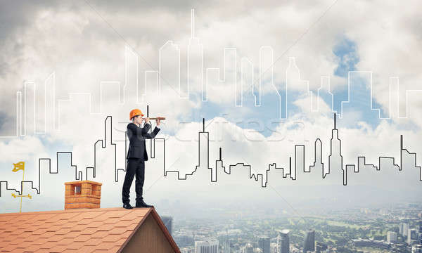 Engineer man standing on roof and looking in spyglass. Mixed med Stock photo © adam121