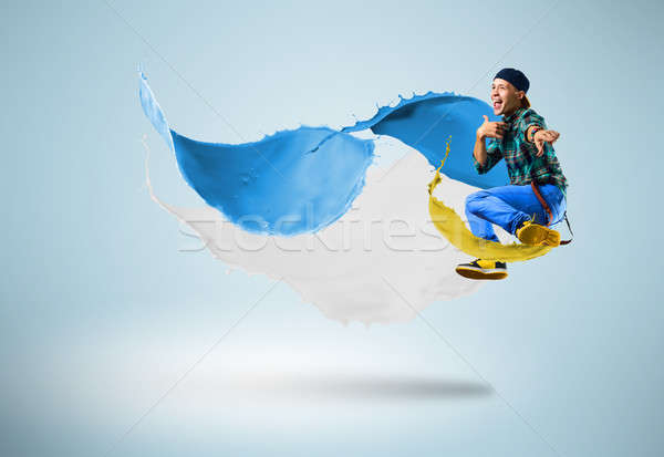 young male dancer jumping with splash of paint Stock photo © adam121