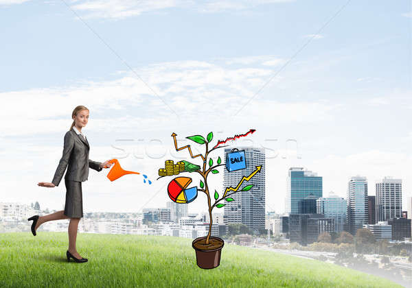 Young businesswoman outdoors watering drawn growth concept with can Stock photo © adam121