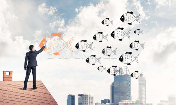 Businessman standing with back on house brick roof and drawing.  Stock photo © adam121