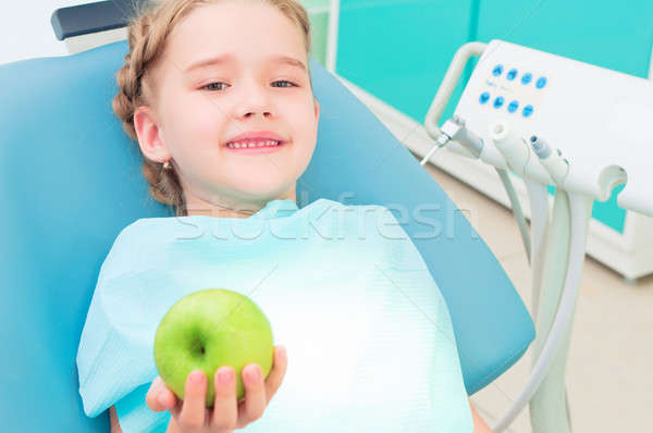 girl in the dentist's chair shows a green apple Stock photo © adam121
