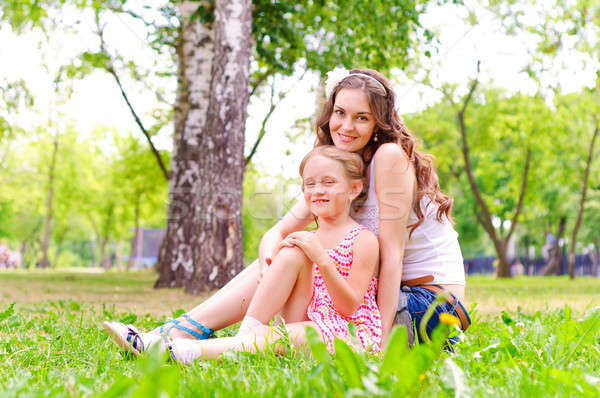 mother and daughter sitting together on the grass Stock photo © adam121