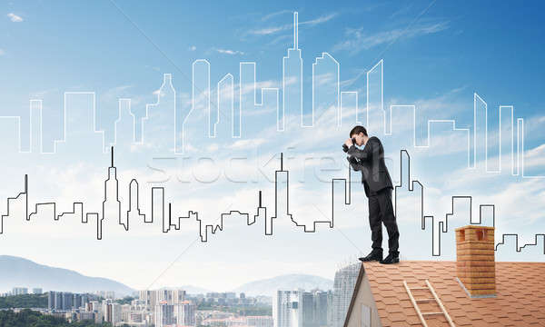 Businessman standing on roof and looking in binoculars. Mixed media Stock photo © adam121