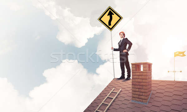 Engineer man on brick roof with sign in hands. Mixed media Stock photo © adam121