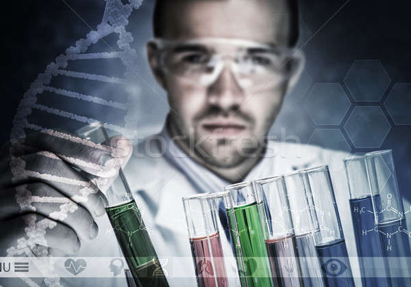 Stock photo: Portrait of concentrated male scientist working with reagents in