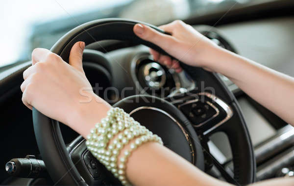 woman's hands holding on to the wheel of a new car Stock photo © adam121