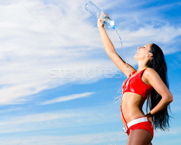 sport girl in red uniform with a bottle of water Stock photo © adam121