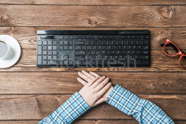 Top view of woman sitting at table with hands folded Stock photo © adam121