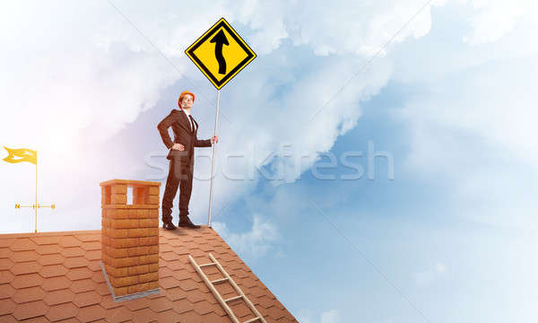 Engineer man on brick roof with sign in hands. Mixed media Stock photo © adam121