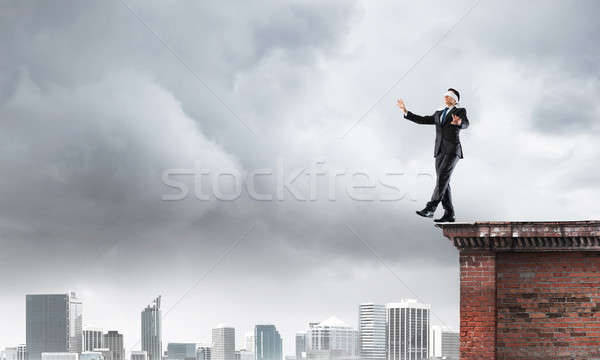 Danger and risk concept with businessman making step from edge Stock photo © adam121