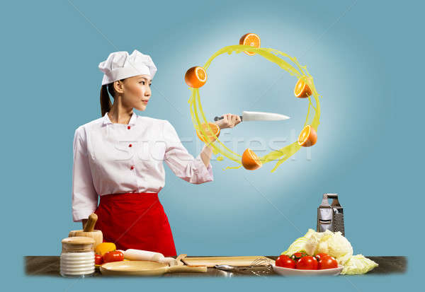 Asian female chef slicing oranges Stock photo © adam121