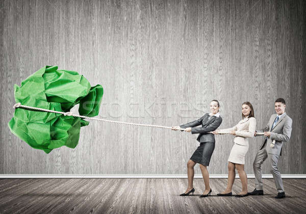 Young business people and huge paper ball as symbol of creativity Stock photo © adam121