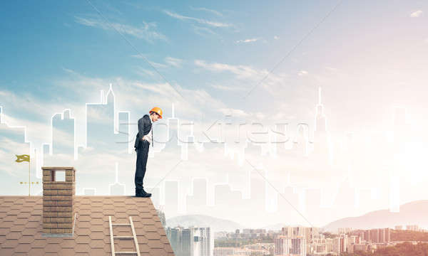Engineer man standing on roof and looking down. Mixed media Stock photo © adam121