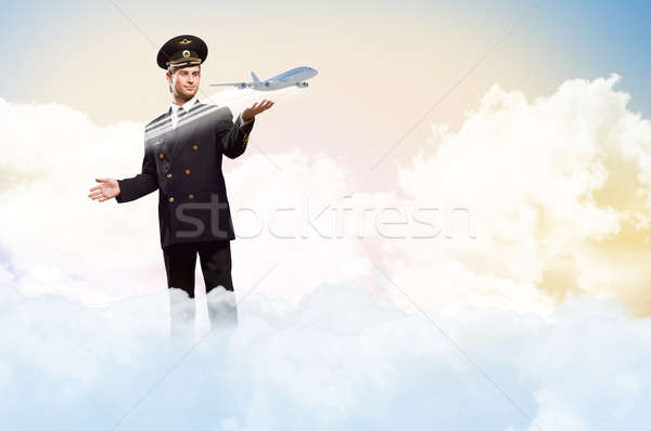 Stock photo: pilot in the form of extending a hand to airplane