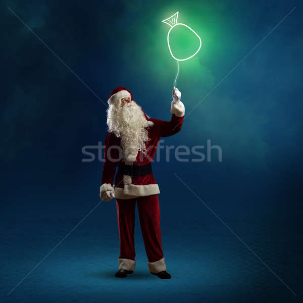 Santa Claus is holding a shining bag Stock photo © adam121