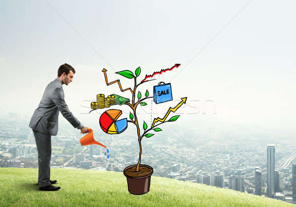 Young businessman outdoors watering drawn growth concept with can Stock photo © adam121