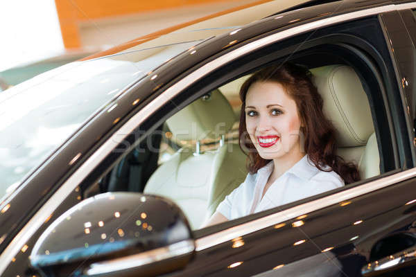 young woman in the new car in the showroom Stock photo © adam121