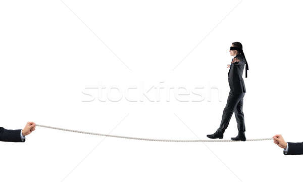 Young businessman in blindfold against white background walking on rope Stock photo © adam121