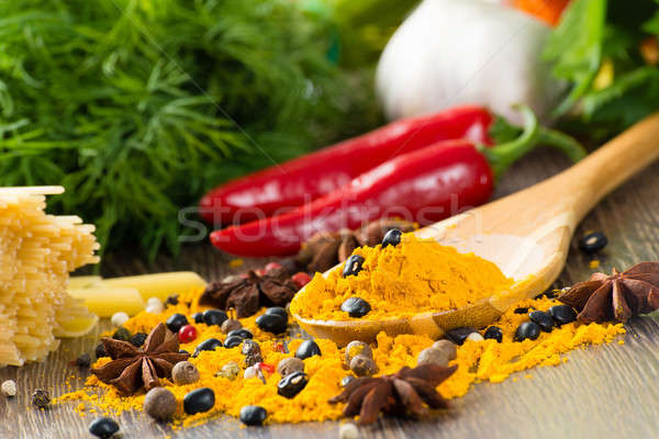 chilli, herbs and spices lie on a wooden surface Stock photo © adam121