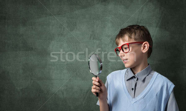 Curious school boy with magnifier Stock photo © adam121