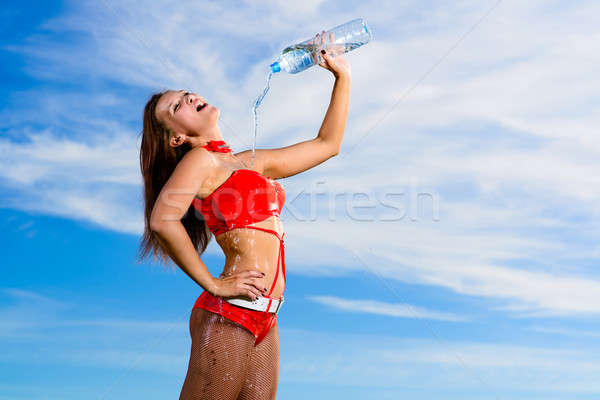 sport girl in red uniform with a bottle of water Stock photo © adam121