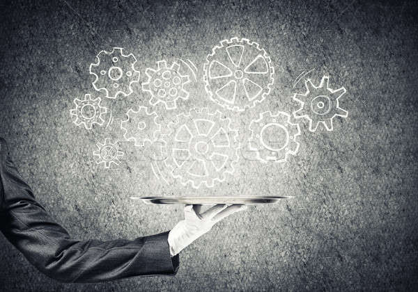 Stock photo: Waiter hand with empty silver tray and drawn gears concept