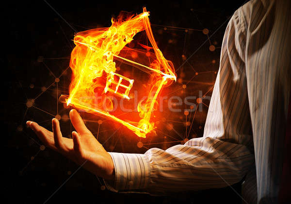 Stock photo: House fire icon in palm
