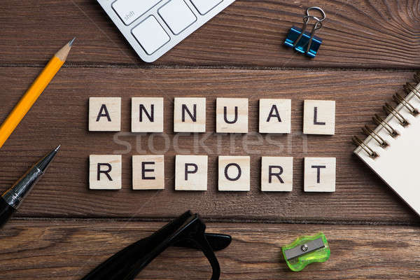 Business workplace with office stuff and wooden cubes spelling Annual Report Stock photo © adam121