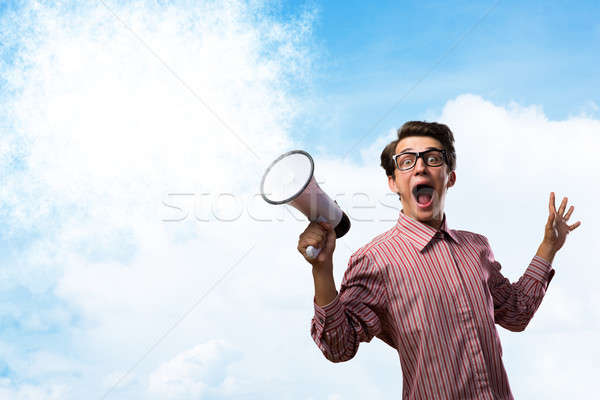 Portrait of a young man shouting using megaphone Stock photo © adam121