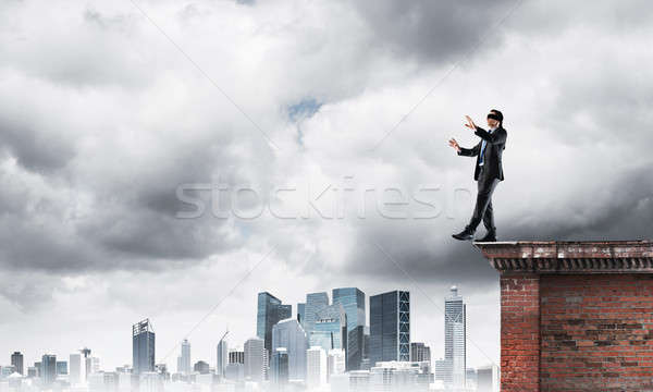 Danger and risk concept with businessman making step from edge Stock photo © adam121