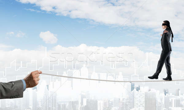 Stock photo: Business concept of risk support and assistance with man balancing on rope