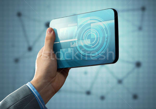 Media technology concept presented by businessman holding tablet with graphs and diagrams Stock photo © adam121