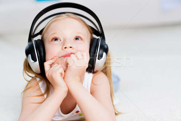 Pretty girl listening to music on headphones Stock photo © adam121