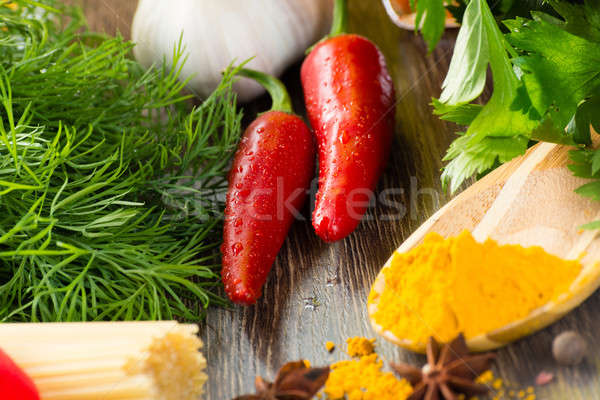 chilli, herbs and spices lie on a wooden surface Stock photo © adam121