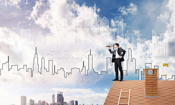 Engineer man standing on roof and looking in spyglass. Mixed media Stock photo © adam121