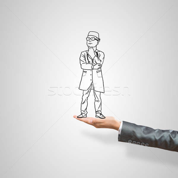 Caricatures of businessman in palm Stock photo © adam121