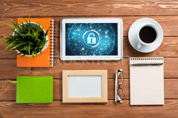 Web security and technology concept with tablet pc on wooden table Stock photo © adam121