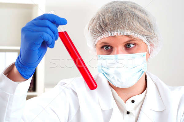 female chemist mixing liquids in test tubes Stock photo © adam121