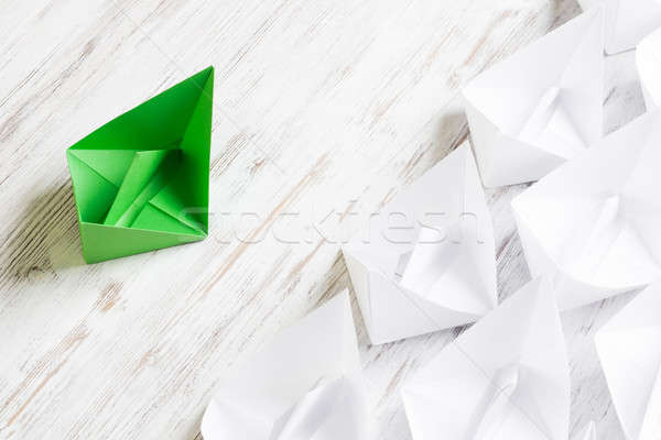 Business leadership concept with white and color paper boats on wooden table Stock photo © adam121