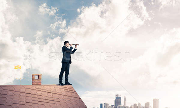 Mister boss on brick roof in search of something new. Mixed medi Stock photo © adam121