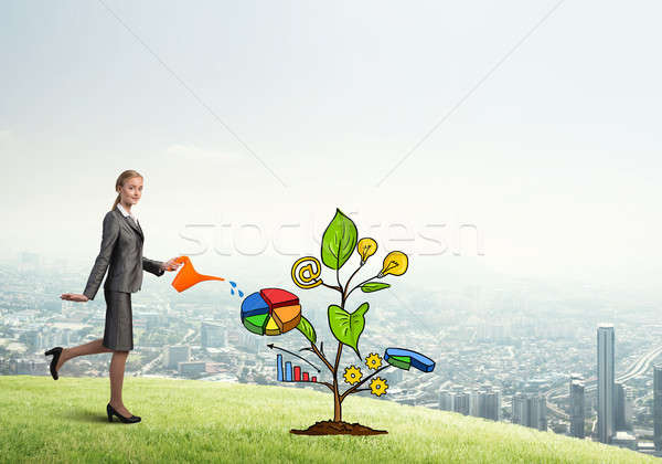 Young businesswoman outdoors watering drawn growth concept with can Stock photo © adam121