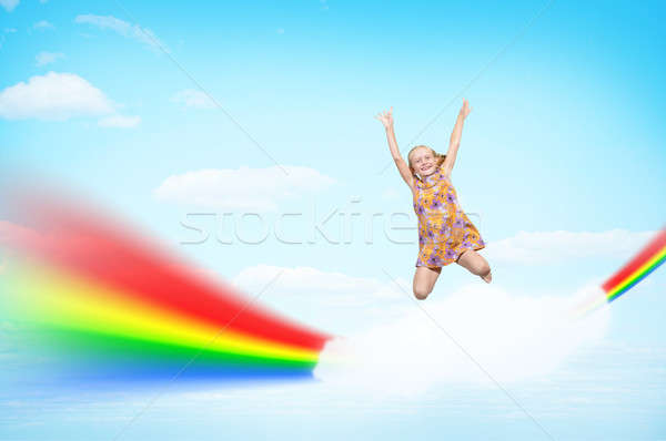 girl jumping on clouds and a rainbow Stock photo © adam121