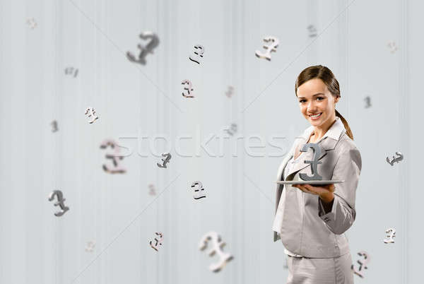 Stock photo: business woman holding a tablet with british pound