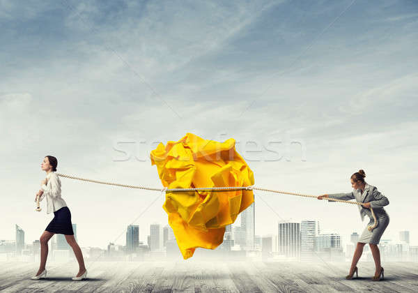 Két nő húz erőfeszítés nagy labda papír Stock fotó © adam121