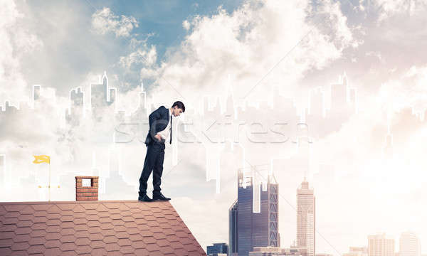 бизнесмен глядя вниз крыши современных Cityscape молодые Сток-фото © adam121