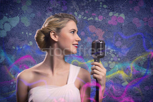 attractive female singer with microphone Stock photo © adam121